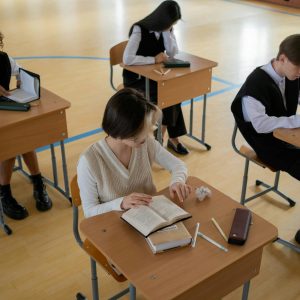 Group of diverse students studying in a well-lit indoor classroom setting.